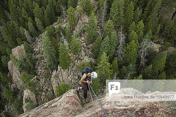 Woman rappels from summit of Matron  Flatirons near Boulder  Colorado