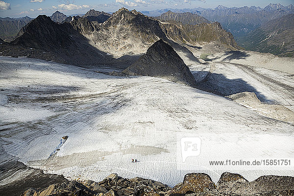 Hikers cross Snowbird Glacier  Talkeetna Mountains  Alaska