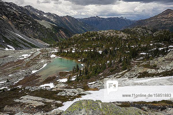 Scenic view of an alpine lake and the surrounding mountains on a summer day in the Coast Mountains of British Columbia.