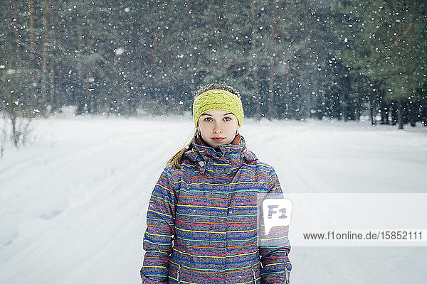 girl standing in a snowy forest