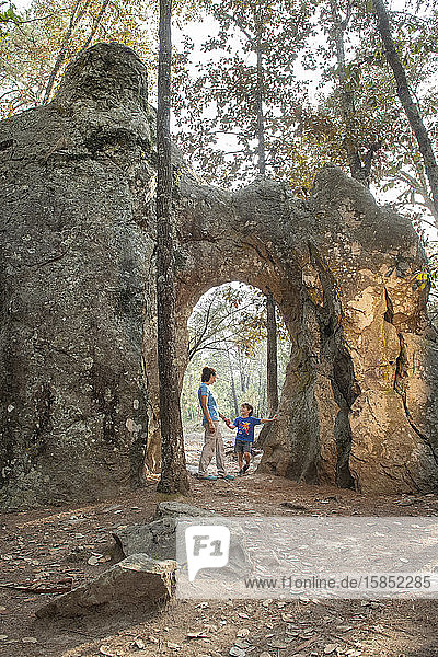 Mom and son under a natural arch in a rock at Huasca de Ocampo Mexico
