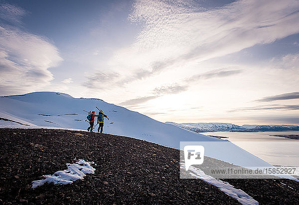 Couple walking with skis on vacation in Iceland