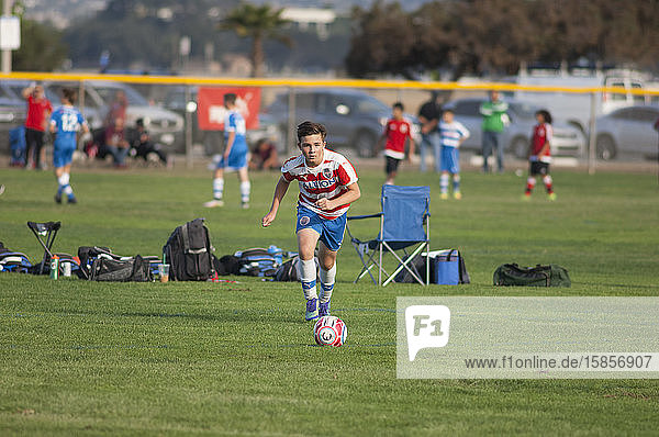 Teen soccer player about to strike the ball on a free kick