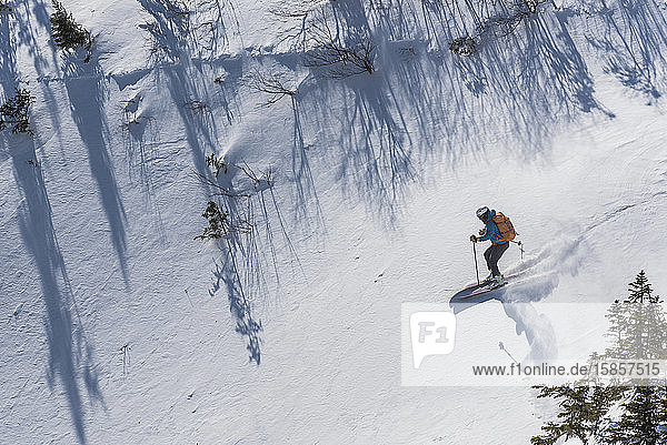A woman skiing in fresh powder near Tuckerman Ravine on Mount washington in the White Mountains of New Hampshire.