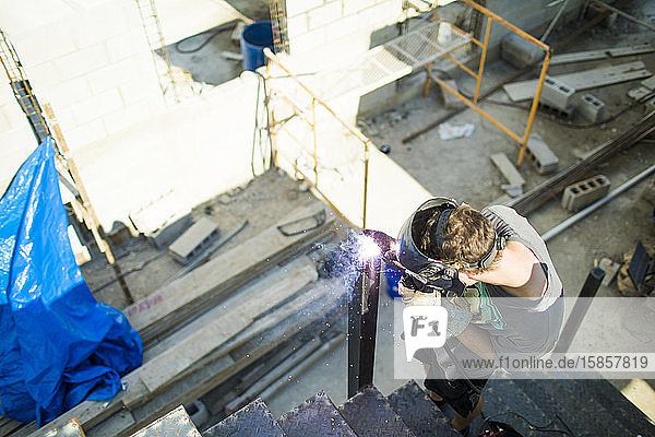 High angle view of man welding on construction site.