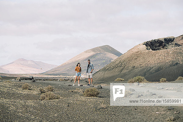 Couple posing outside the Volcano Cuervo in Lanzarote  Timanfaya.