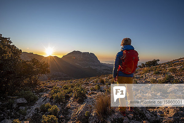 A woman hiking in the high country  El Divino mountain  Costa Blanca