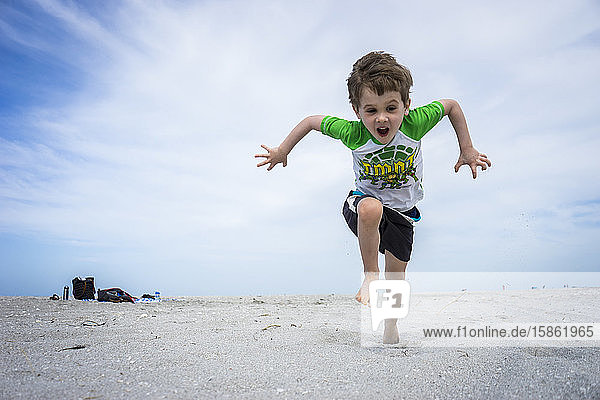 Young boy running on beach