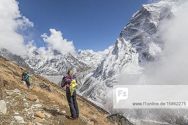 Women mountaineers pose for photos among spectacular mountain backdrop