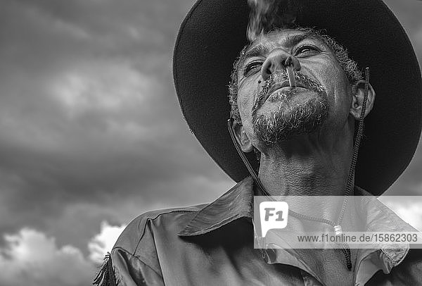 Portrait of Brazilian cowboy smoking handmade cigarette