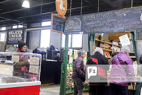 Women shopping in at Les Jardins Sauvages  Jean Talon Market