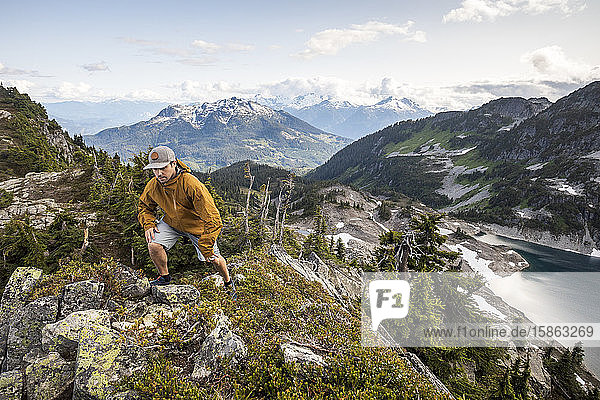 A man hikes along an alpine ridge in the mountains.