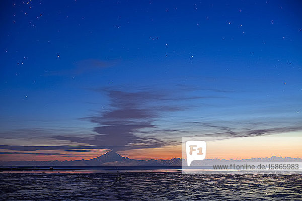 Ash Cloud Rises From Mt. Redoubt At Sunset During Low Tide Near Ninilchik Alaska