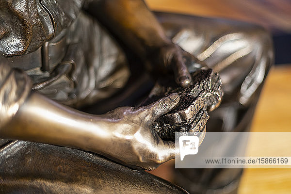 Close-up of a statue of worker eating a sandwich Empire State Building; New York City New York United States of America