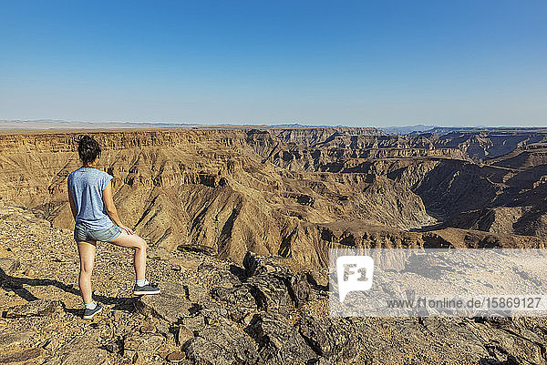 Weibliche Touristin steht und schaut über den Fischfluss-Canyon; Namibia