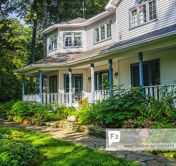 House with front yard garden and walkway; Hudson Quebec Canada
