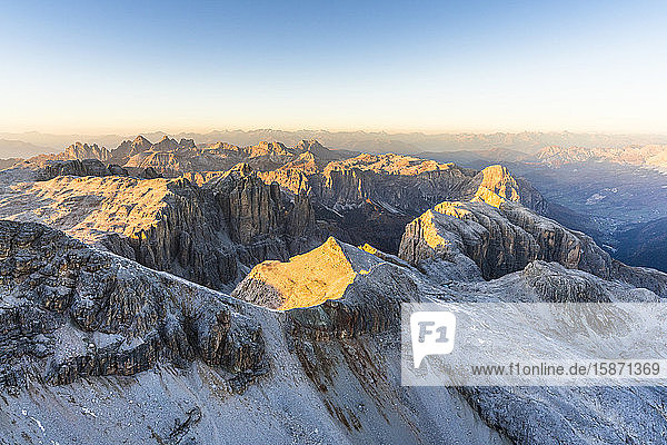 Aerial view of sunset over Sella Group and Odle mountain range in autumn Val Gardena Val Funes Dolomites South Tyrol Italy Europe
