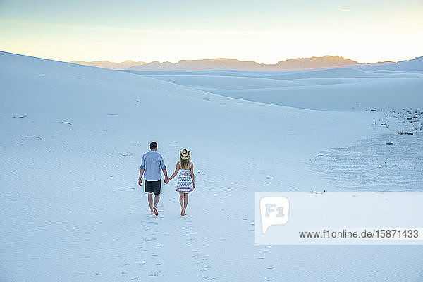 A couple enjoy White Sands National Park at sunset  New Mexico  United States of America  North America