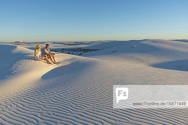 A couple enjoys White Sands National Park at sunset  New Mexico  United States of America  North America