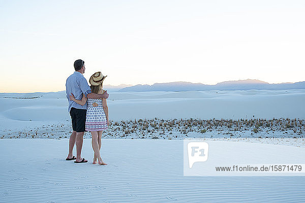 A couple enjoy White Sands National Park at sunset  New Mexico  United States of America  North America