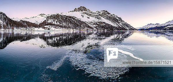 Panoramic view of the icy surface of Lake Sils at sunrise Engadine Valley Graubunden Swiss Alps Switzerland Europe