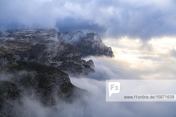 Sunlight over Croda dei Toni through the autumn fog covering Auronzo Valley Sesto Dolomites Trentino-Alto Adige/Veneto Italy Europe
