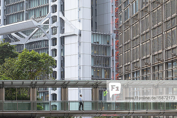 Man crossing footbridge, Admiralty, Hong Kong, China, Asia