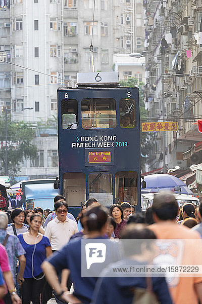 Tram passing along Chun Yeung Street market, North Point, Hong Kong Island, Hong Kong, China, Asia