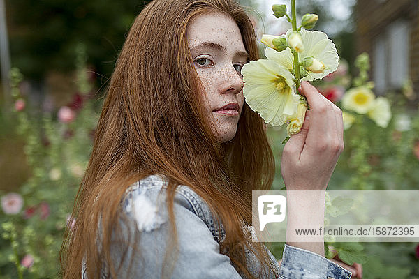 Teenage girl holding flower