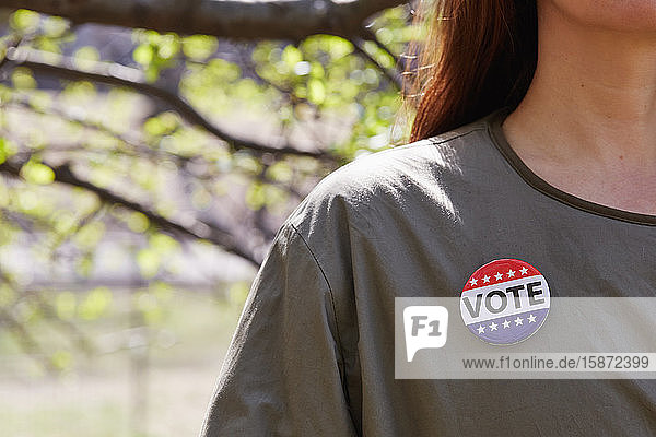 Woman with vote button on her top