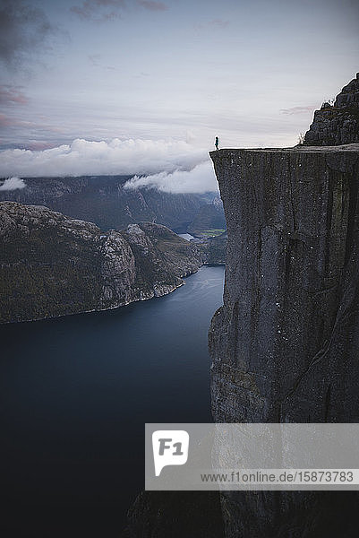 Person standing on Preikestolen cliff in Rogaland  Norway