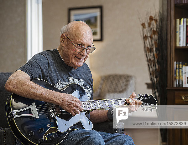 Senior man playing guitar