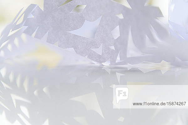 Paper snowflake on glass table