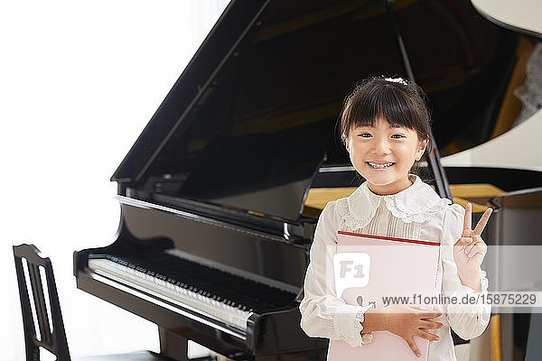 Japanese kid practicing piano