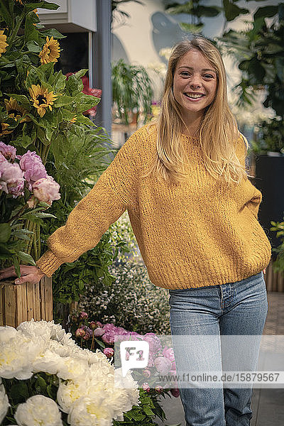 Young woman standing in flower shop