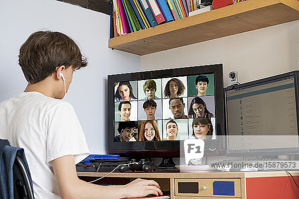 Jugendlicher  der zu Hause mit seinen Freunden am Computer videochattet