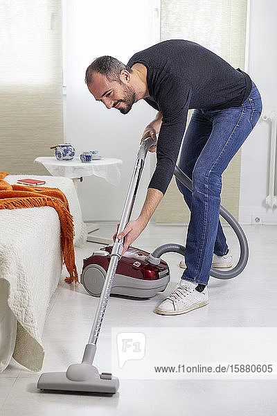 A man vacuuming.