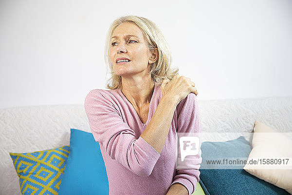 Eine Frau in den Fünfzigern mit Schulterschmerzen.