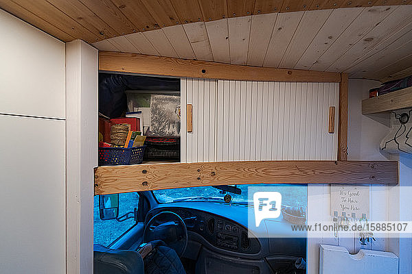 Cupboard over the campervan driving cabin with sliding doors.