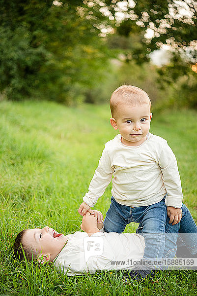 Portrait of two young boys playing in a meadow.