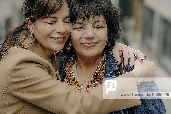 Portrait of happy woman hugging her mother