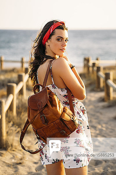 Young girl with leather bag at the beach
