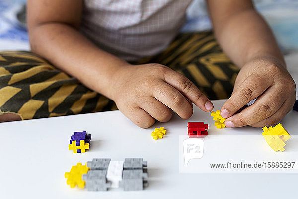 Children's hands playing with building blocks