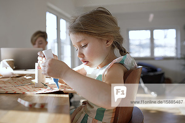 Portrait of little girl tinkering at home
