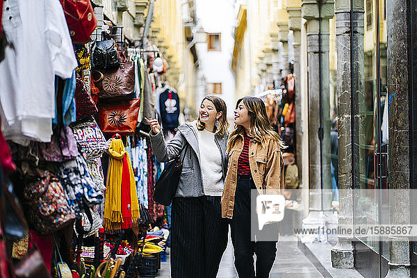 Two happy young women shopping in the city