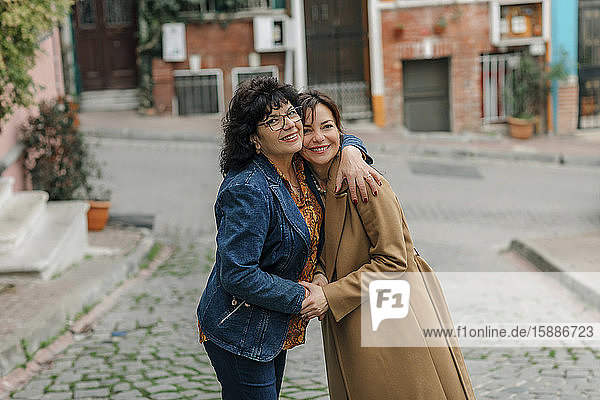Portrait of happy mother hugging adult daughter on the street  Istanbul  Turkey