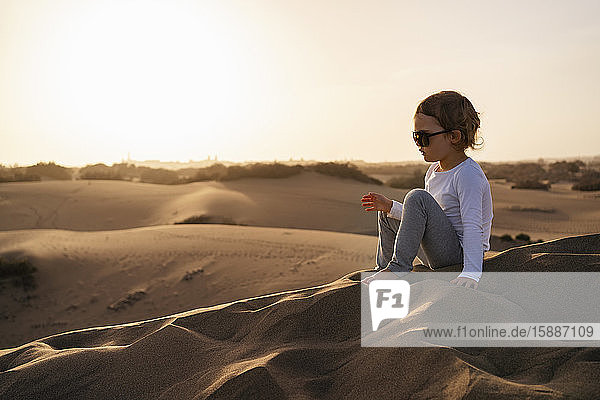 Girl sitting in sand dunes  Gran Canaria  Spain