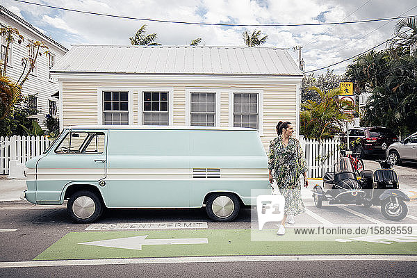 Woman crossing a road in Key West  Florida  USA