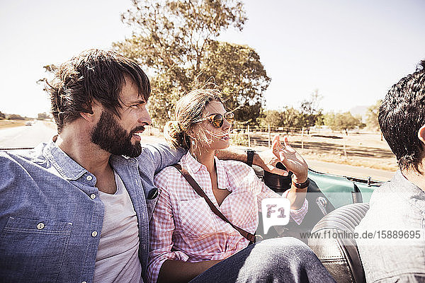 Couple in convertible car on a road trip