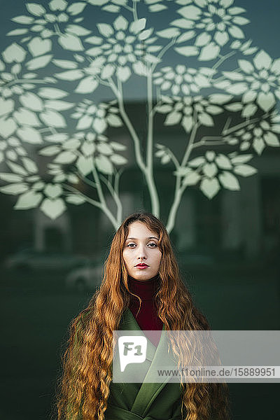 Portrait of redheaded young woman with red lips